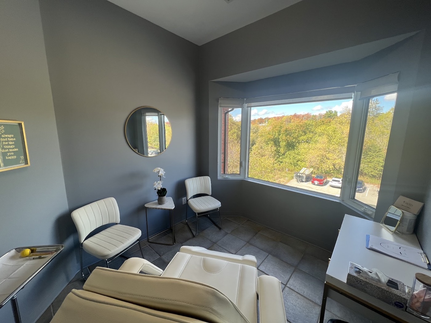 Treatment room at Faces Aesthetics Alliston with a bay window overlooking the town